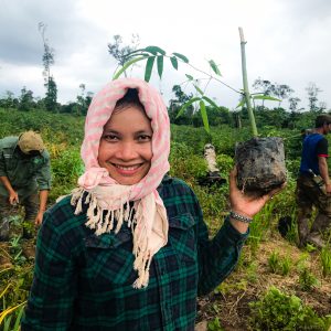 A young girl holds a tree sapling during tree planting operations in the Keo Seima project, Cambodia. (C) WCS.