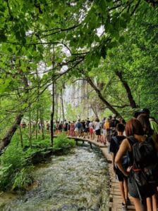 People overcrowded on a path in Plitvice Lakes National Park, Croatia 